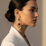 Woman wearing elegant earrings with a neutral background
