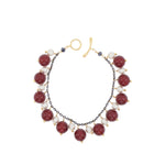 Bracelet with burgundy and white beads on a white background
