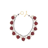 Bracelet with burgundy and white beads on a white background