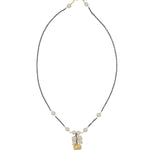 Necklace with white pearls and gold discs on a white background