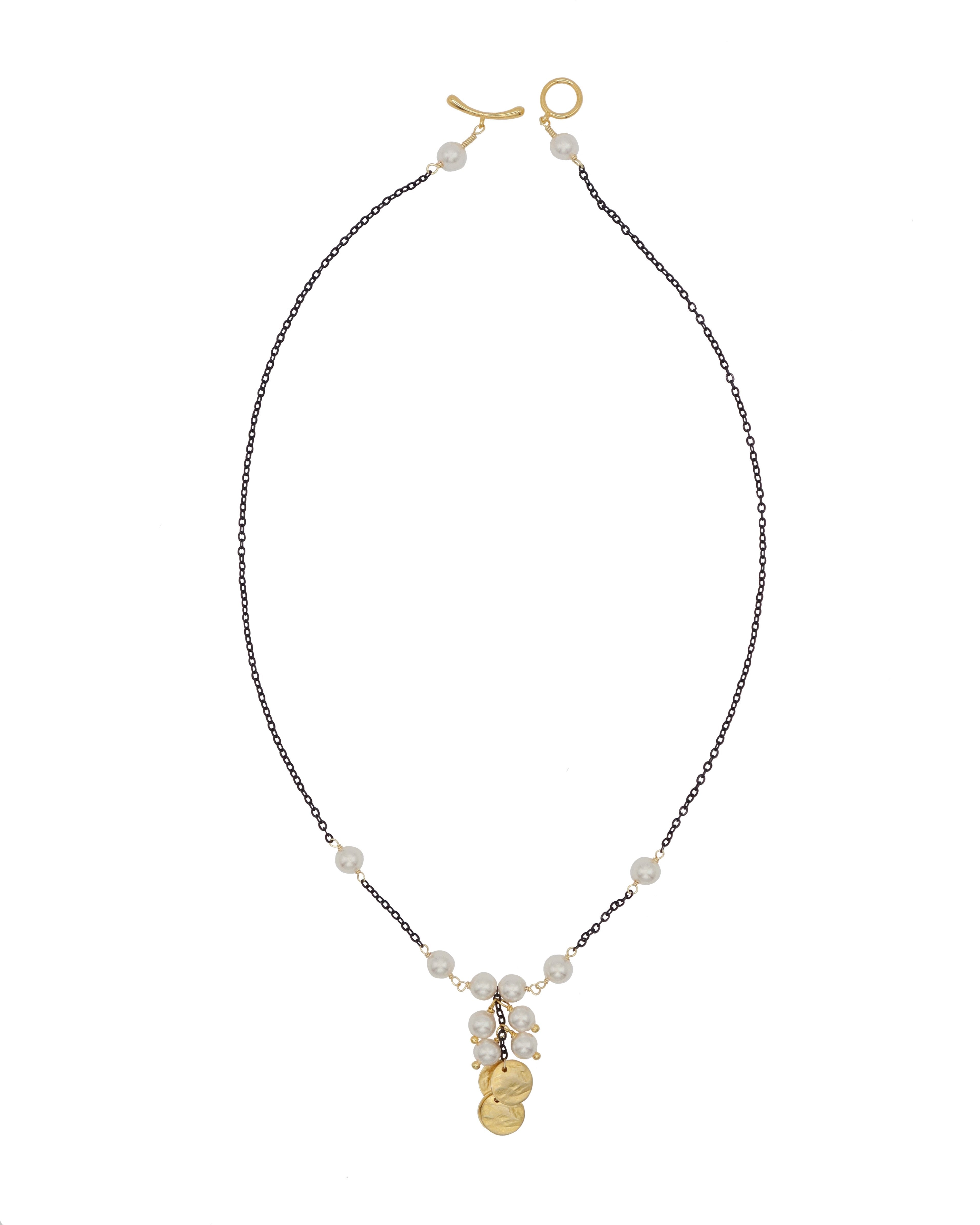 Necklace with white pearls and gold discs on a white background