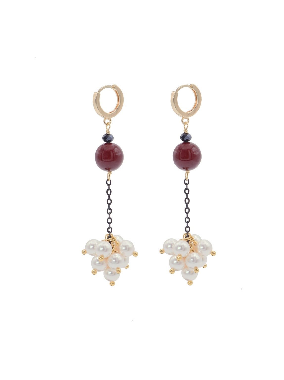 Pair of earrings with burgundy beads and pearl-like elements on a white background