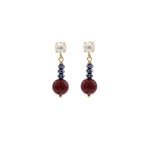 Pair of earrings with burgundy and jet  beads and pearl-like tops on a white background