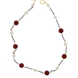 Necklace with burgundy and white beads on a white background
