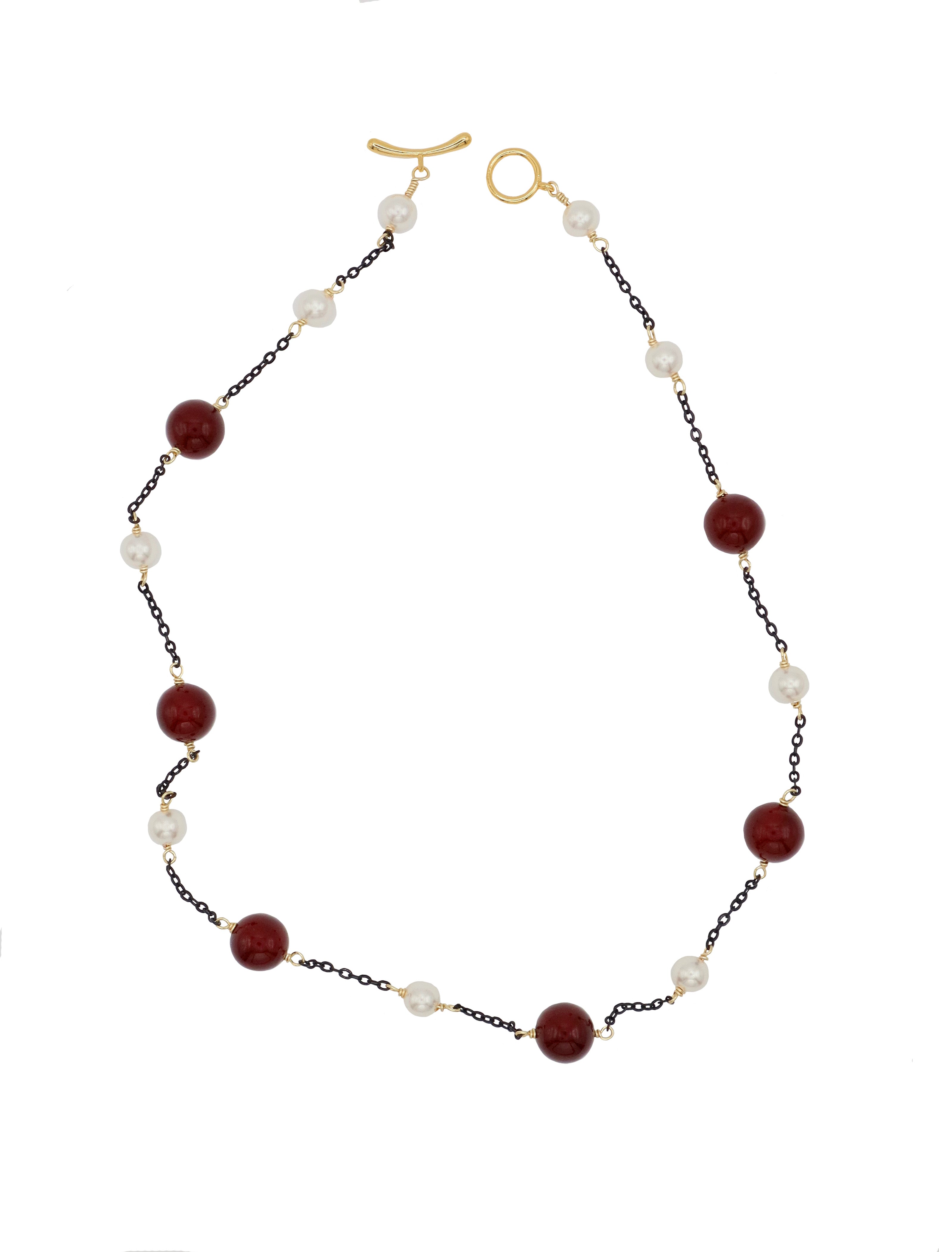 Necklace with burgundy and white beads on a white background