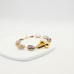 Translucent glass bead bracelet with gold geometric centrepiece