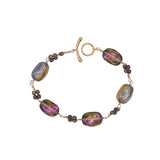 Bracelet with colorful beads and gold clasp on a white background