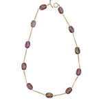 Necklace with irredescent beads on a white background