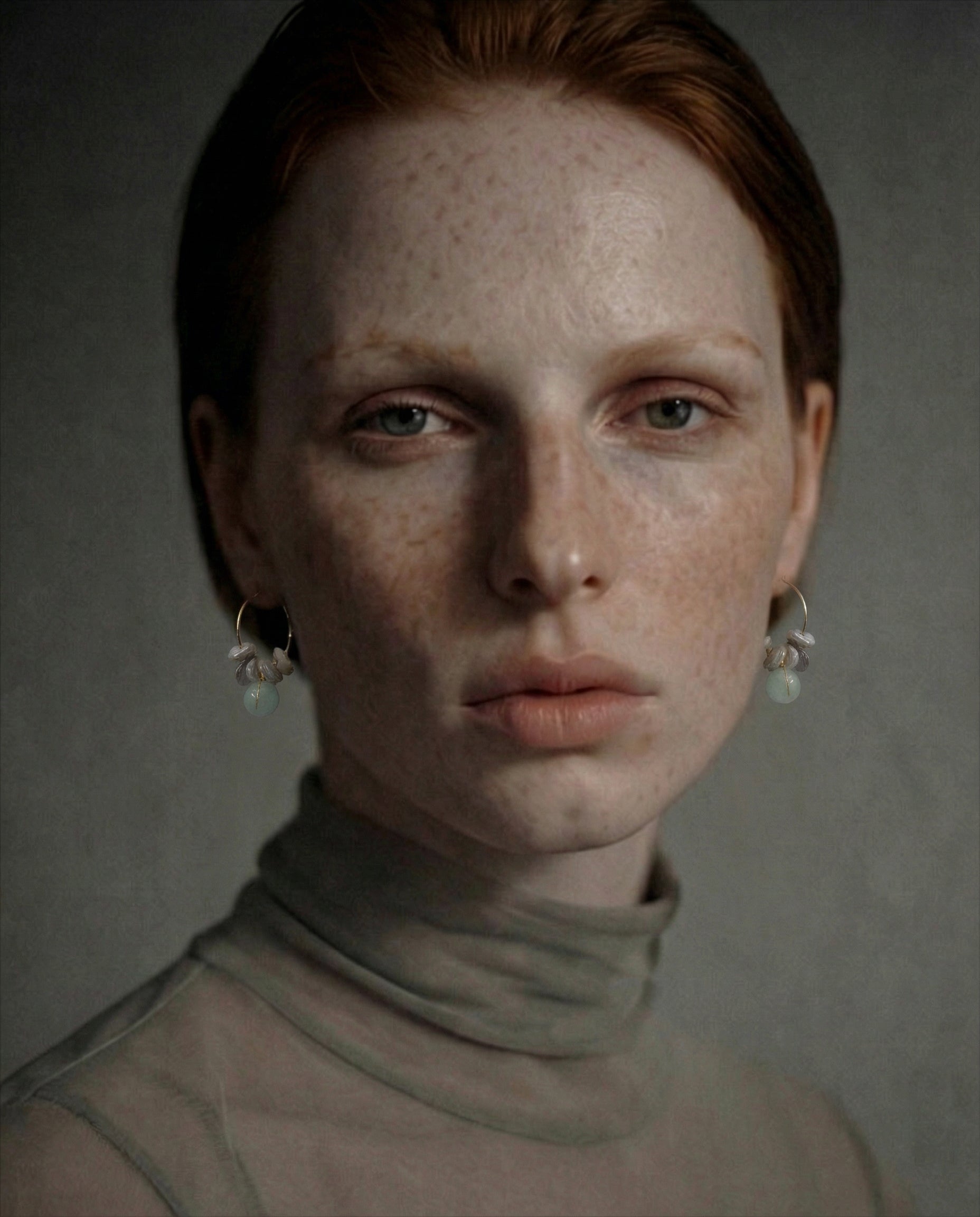 Woman wearing mini hoop earrings with freshwater pearl flakes and aquamarine stones