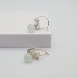 Pair of earrings with aquamarine beads and freshwater pearls on a white background
