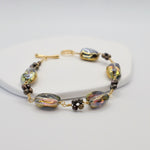 Bracelet with gold and bronze beads on a white background