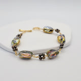 Bracelet with gold and bronze beads on a white background
