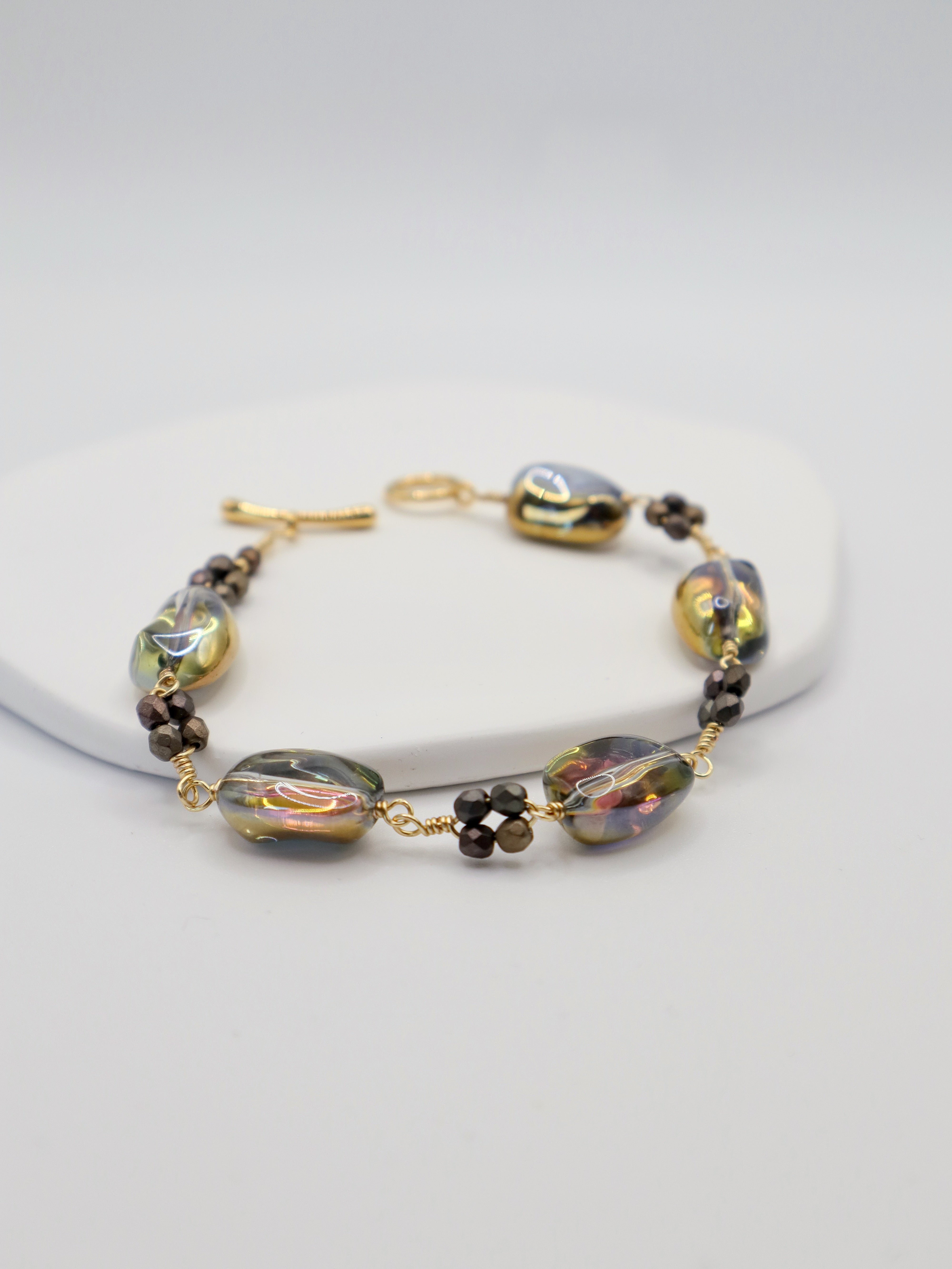 Bracelet with gold and bronze beads on a white background