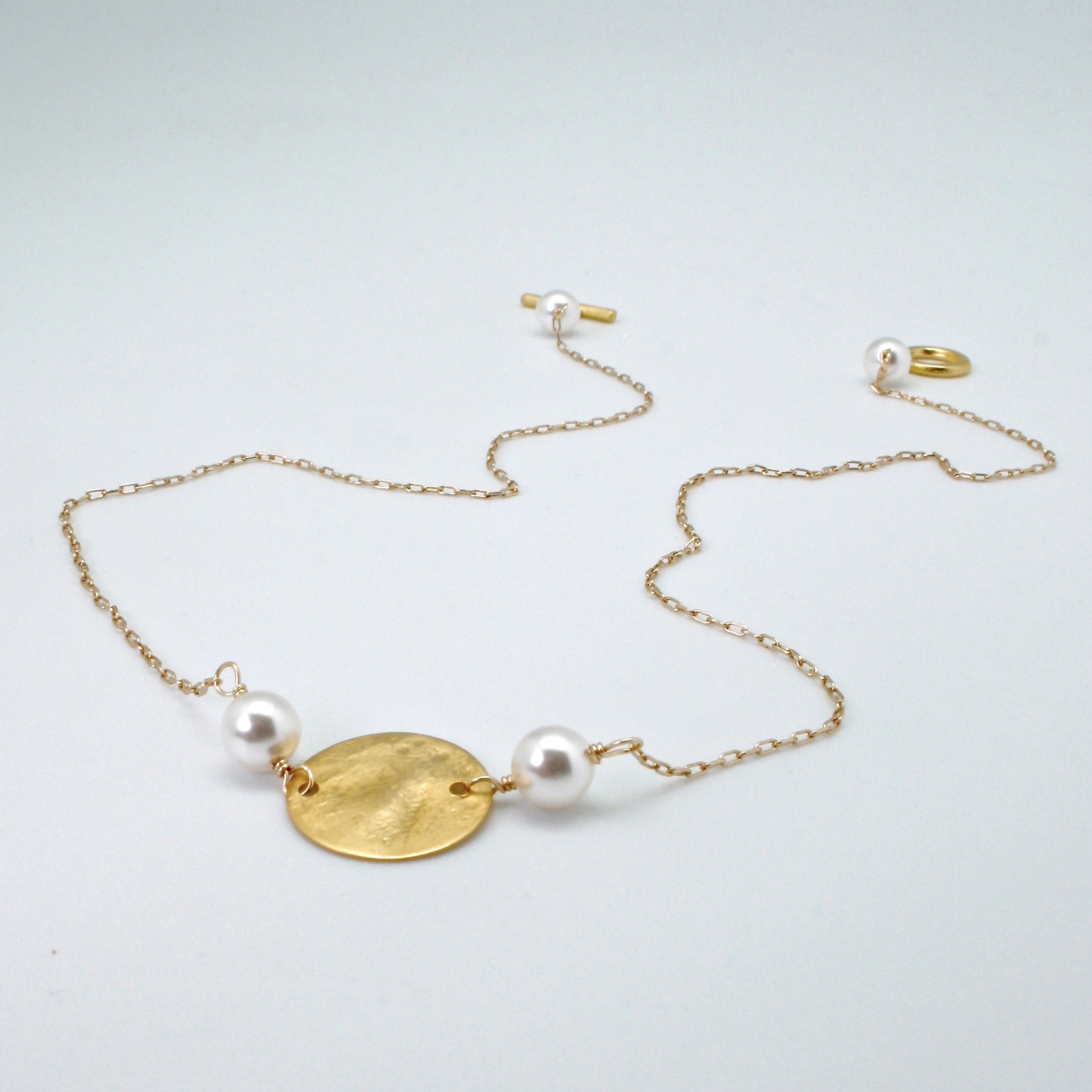 gold disc necklace lying flat by vivien walsh